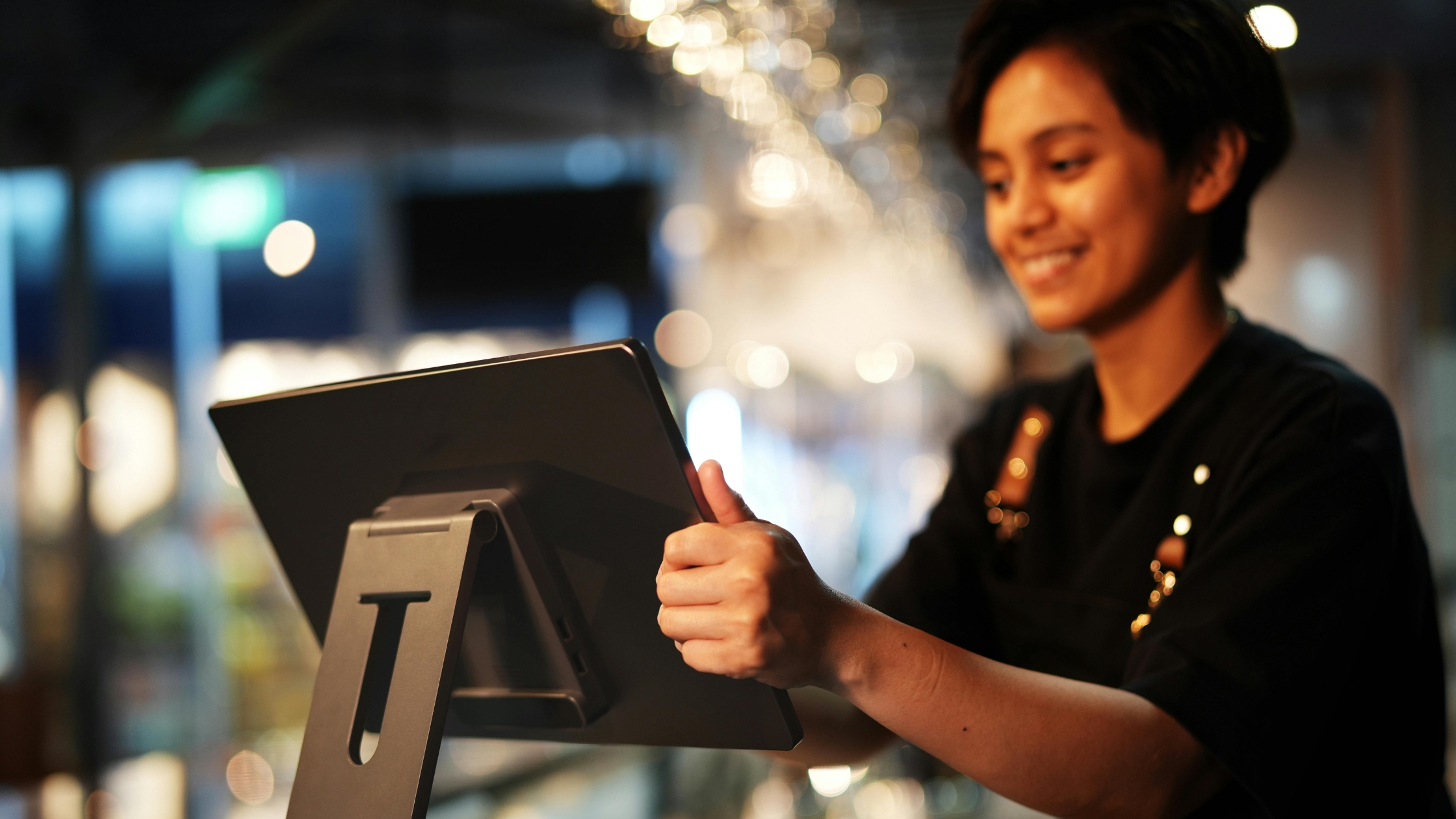 a woman operating a pos