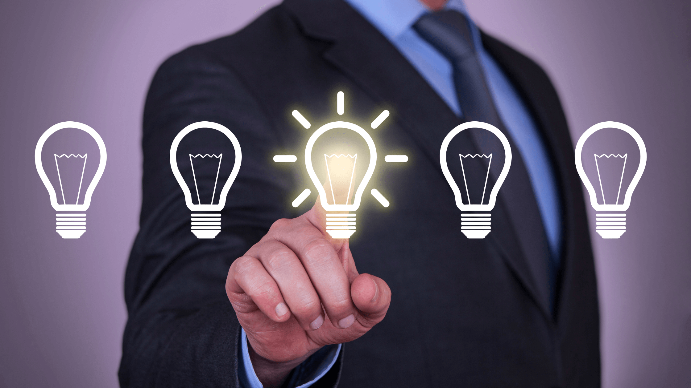 Businessman in a suit touching a glowing light bulb icon among several outlined bulbs, representing innovation and idea selection.