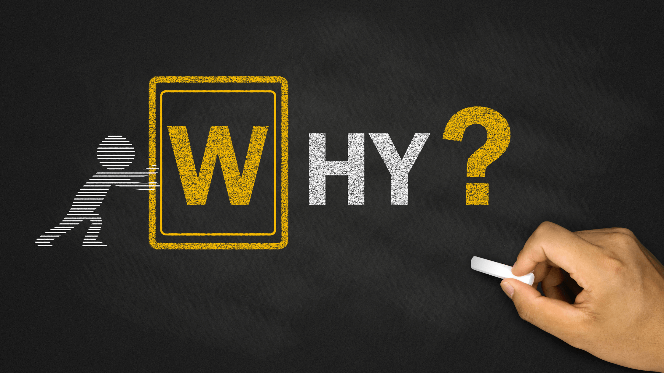 Hand drawing the word “WHY?” in yellow and white chalk on a blackboard.